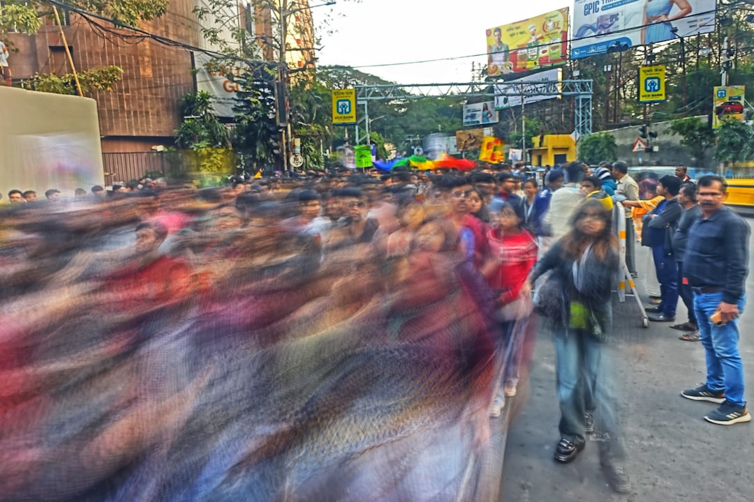 A crowd of people walking down a street